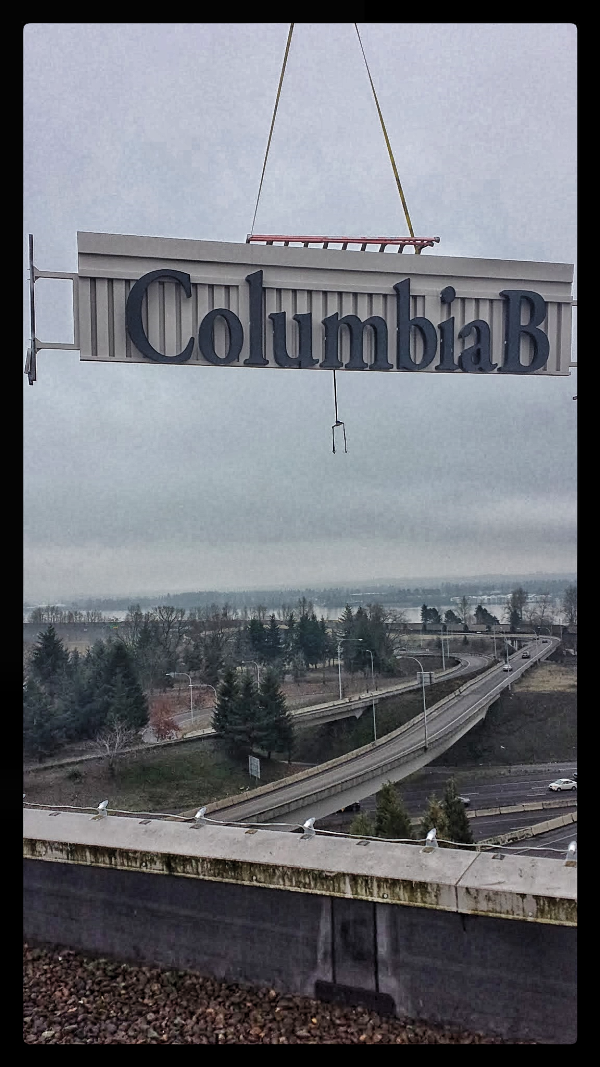 Columbia Bank Vancouver hoisting onto building top