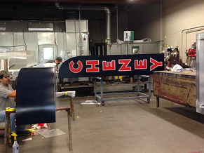 Plumb Signs manufacturing team assembling signs